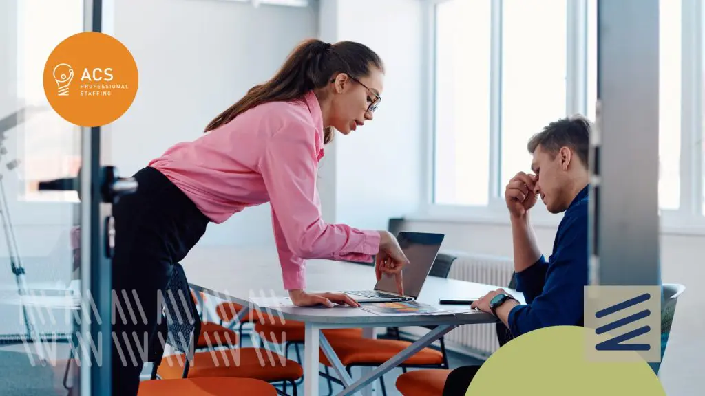 A man stressed out talking to a difficult manager.